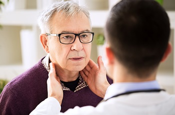 patient looking at doctor during throat examination